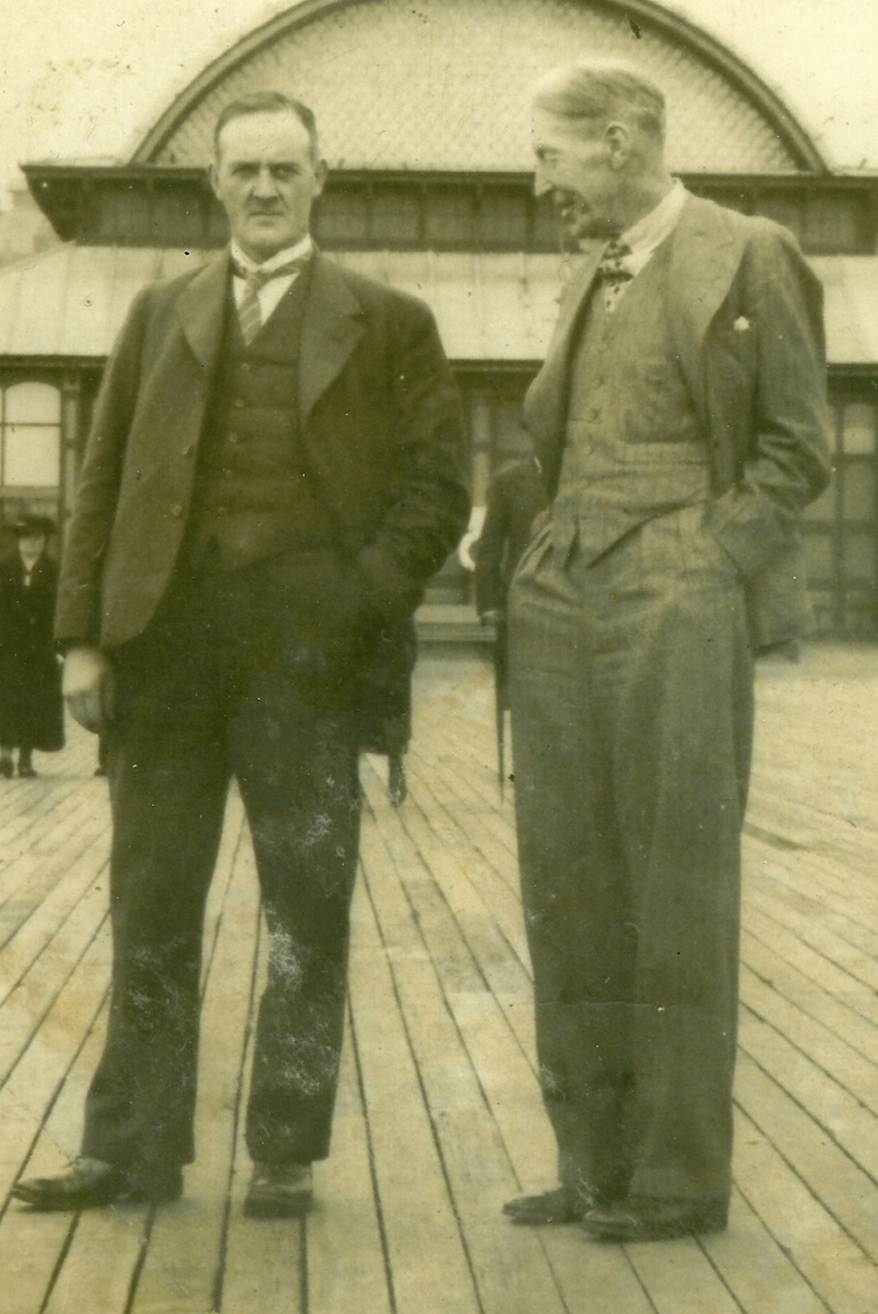 A couple of men standing on a deck

AI-generated content may be incorrect.